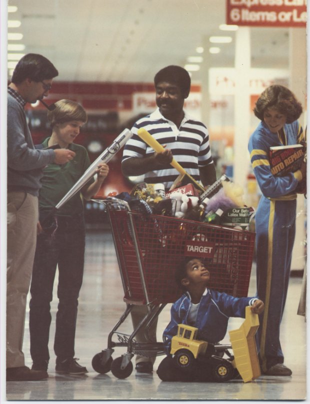a group of people pushing a person in a shopping cart