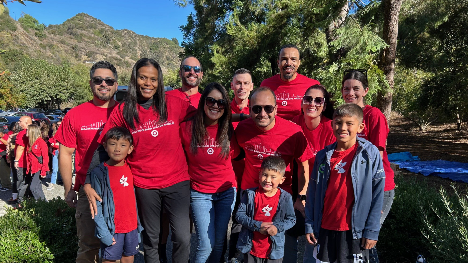 A group of Target volunteers stand outdoors and smile for a photo.