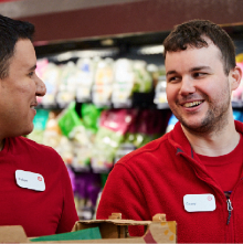 Two Target team members smiling in the grocery department