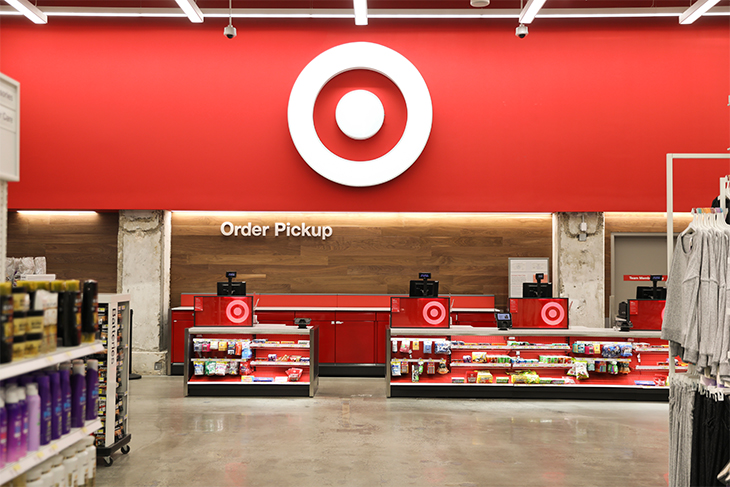 The Order Pickup counter inside a Target store, against a red wall with white bullseye logo and product displays