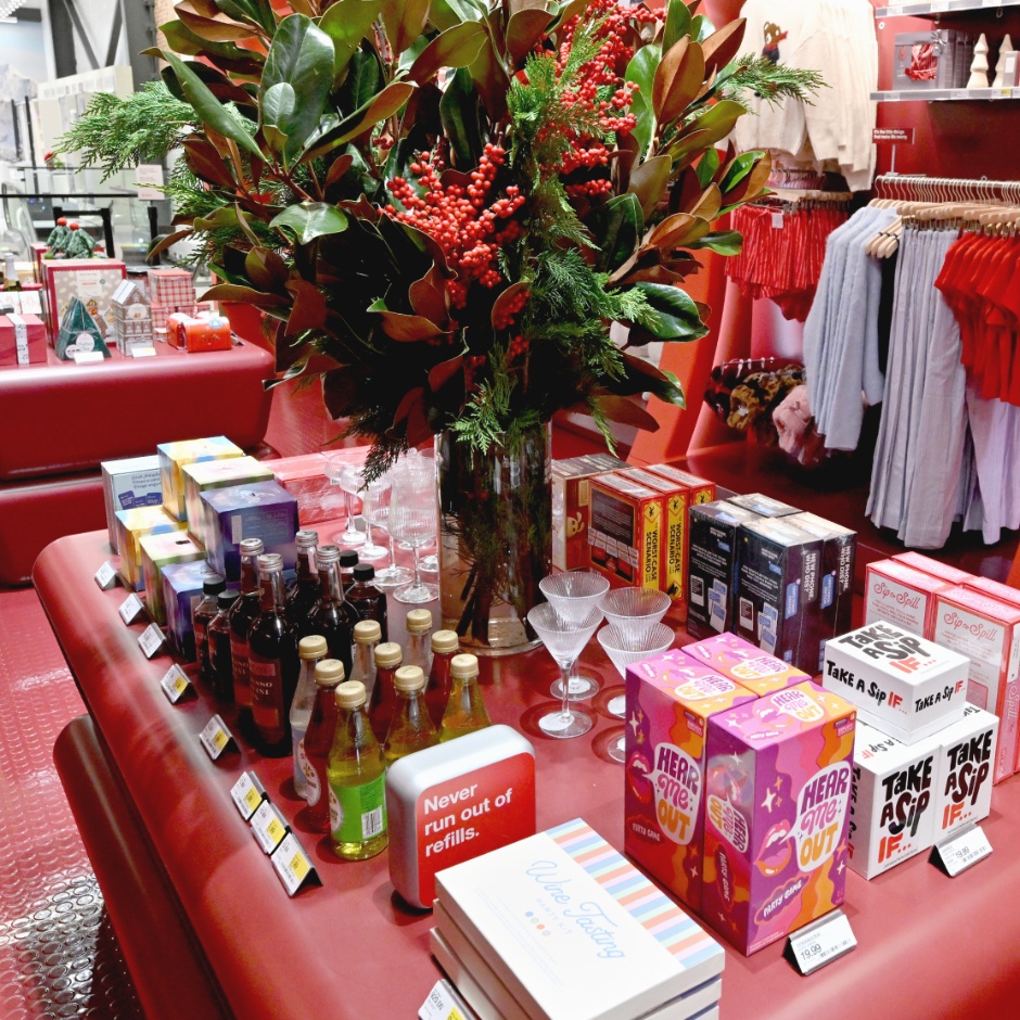 a red cushioned table covered in gifts and games in the Target SoHo store.