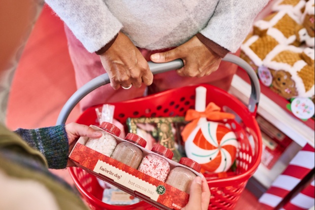 Close-up of a red Target basket holding a cocoa bar kit and holiday treats.
