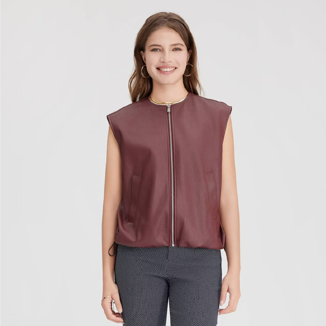 a model wearing a faux leather vest