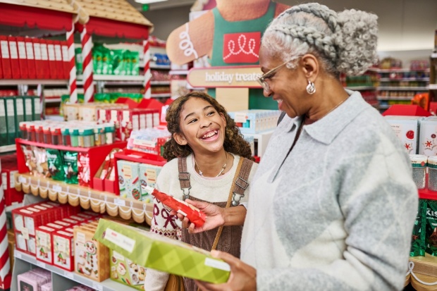 A detailed view of guests holding holiday treat products inside a Target store.