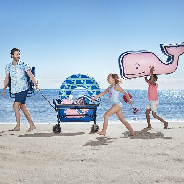 a group of people walking on a beach with umbrellas