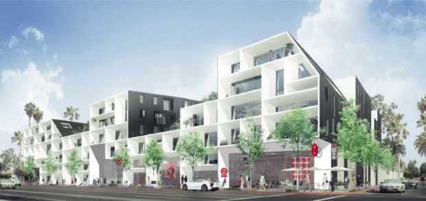 a large white building with trees and cars in front of it