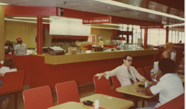 a group of people sitting at a table in a restaurant