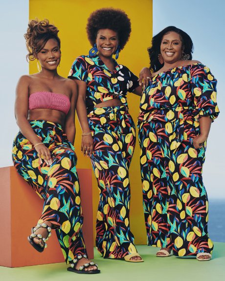 a group of women in colorful dresses