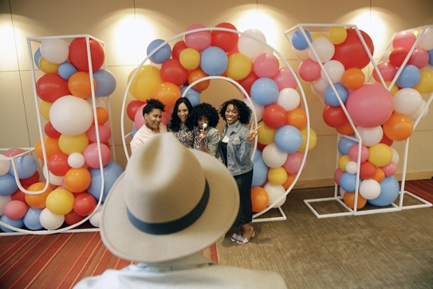 a man and woman in a room with balloons