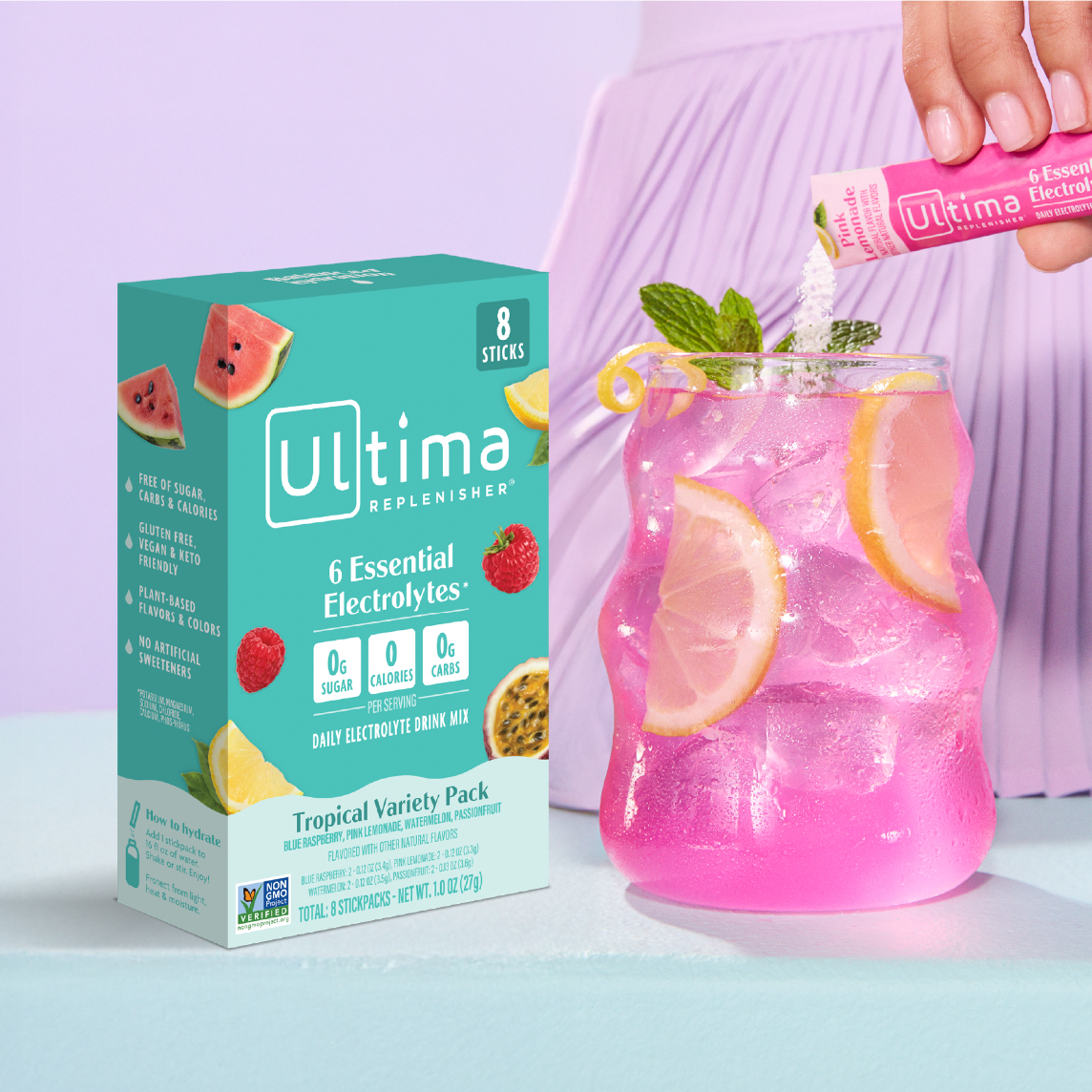 A box of Ultima mixes alongside a person pouring powder into a pink drink.