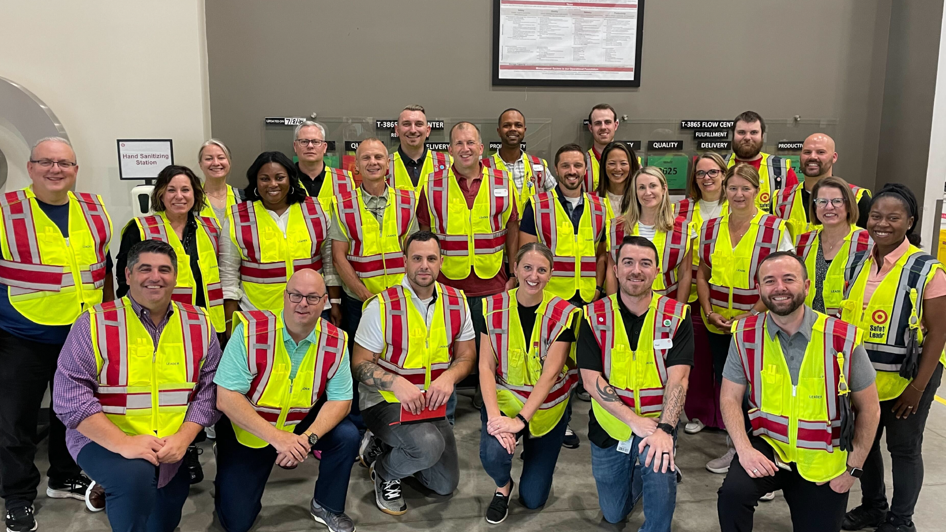 Michael Fiddelke smiles for a photo with Target team members in a flow center.