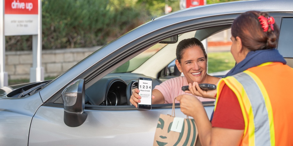 a man holding a phone and a woman in a car