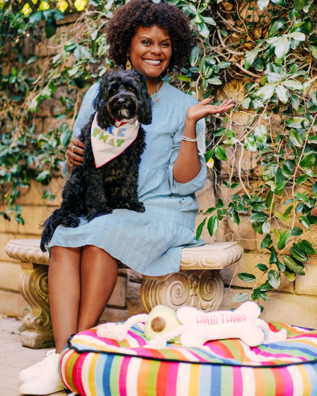 a person sitting on a bench with a dog