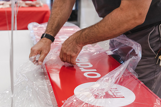 Hands unwrapping a sign