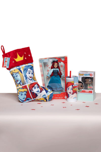 Display of Disney princess-themed items including stocking, doll, and tumbler with straw.