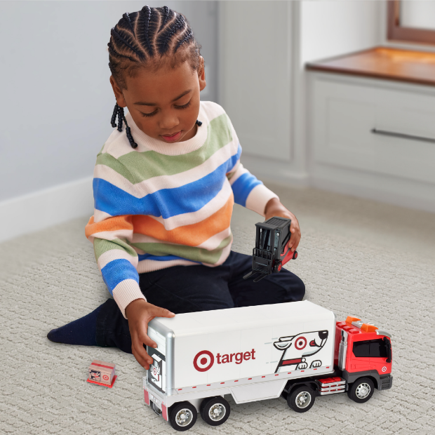 A child plays with a toy truck.