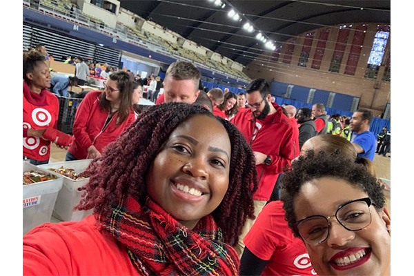 Cathia and her teammates take a selfie as they pack donations at an event