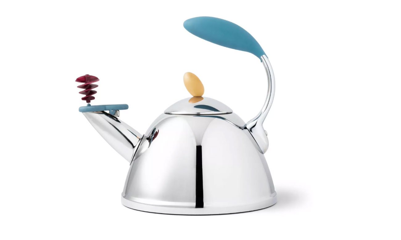 A silver tea kettle with red, yellow and aqua features including a curved handle