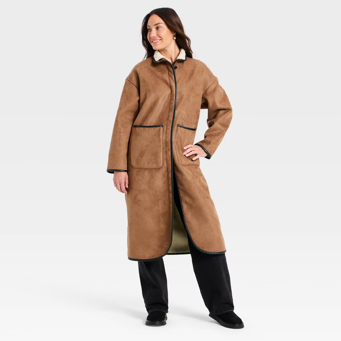 a model wearing a brown suede coat