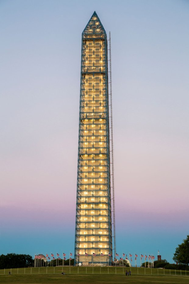 a tall building with flags in front of it