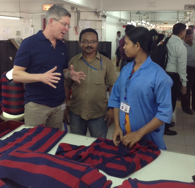 a few people standing next to a table with a flag