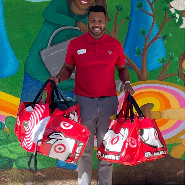 A Target team member holding shopping bags.