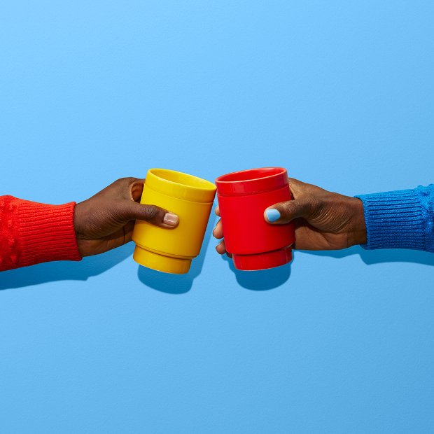 close-up of hands holding cups