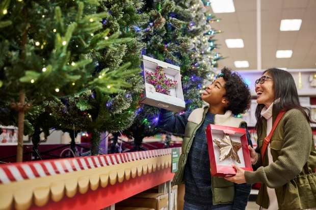 A detailed view of guests exploring holiday products in the Holiday Market display inside a Target store.