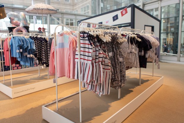 a display of clothes and umbrellas