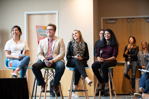 a group of people sitting on stools