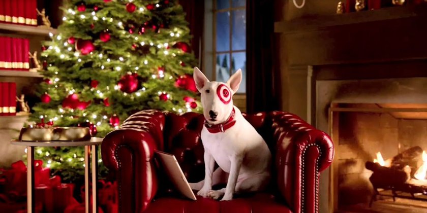 a dog sitting on a chair in front of a christmas tree