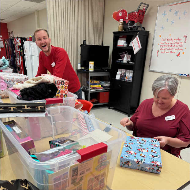 Team Members Tim B. and Corinne W. at Target’s D’Iberville store smile and wrap presents.