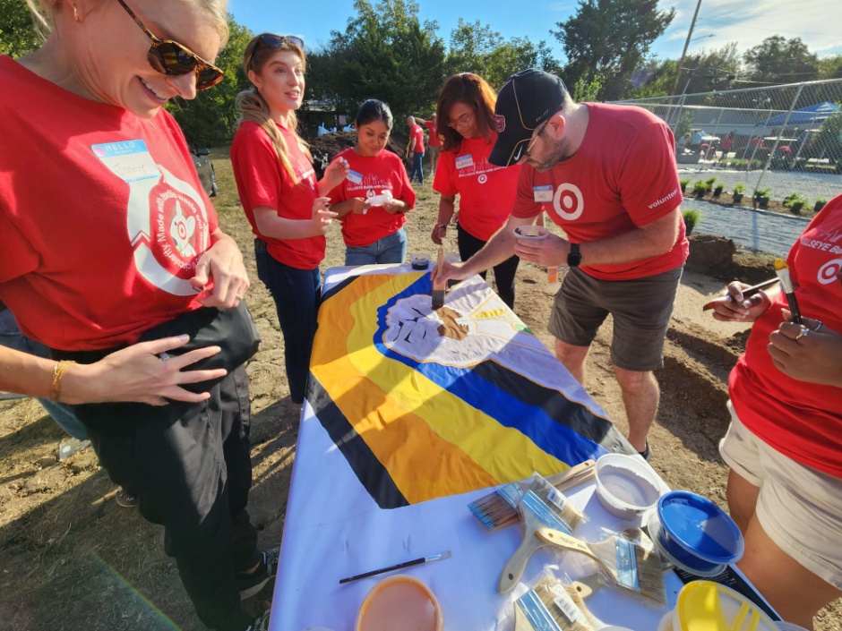 Target team members help paint a sign.