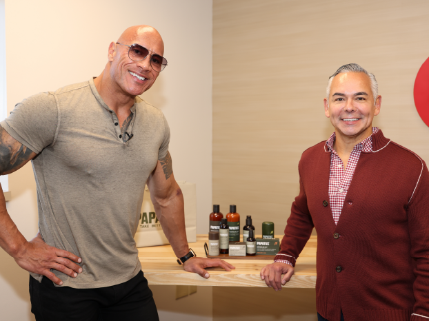 Dwayne "The Rock" Johnson and Rick Gomez smile next to Papatui products from Target.